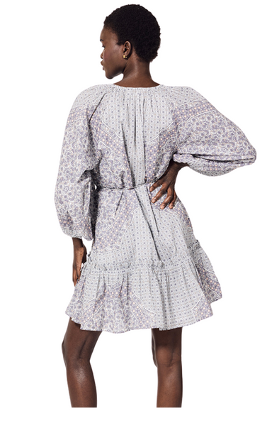 The Benita Mini Dress by Cleobella features a placed print at the body and sleeves. A skirt flounce with a mini ruffle detail adds a unique tough to this dress. Printed long sleeve cotton mini dress.