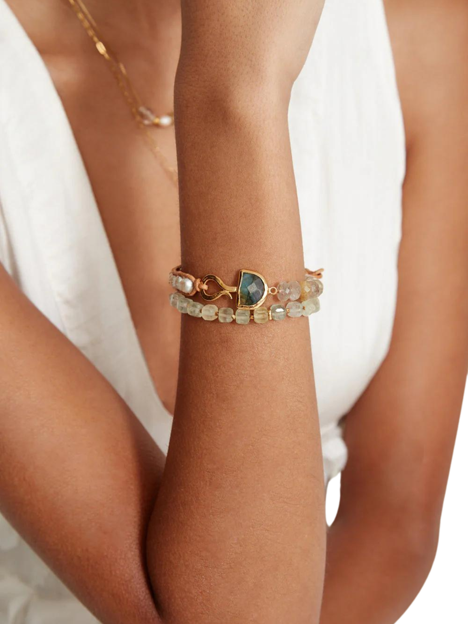 Luna single wrap bracelet This bold single wrap bracelet features faceted rutilated quartz beads, pearls woven between natural leather, and a half moon labradorite pendant secured with a distinctive hook. By Chan Luu.