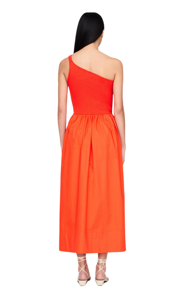 Marie Oliver The Tobie Dress features a sleek one-shoulder silhouette that’s elevated by the contrast between the fitted ribbed knit bodice and full cotton poplin skirt. Tobie is pictured here in Fuego, a fiery orange hue for summer.