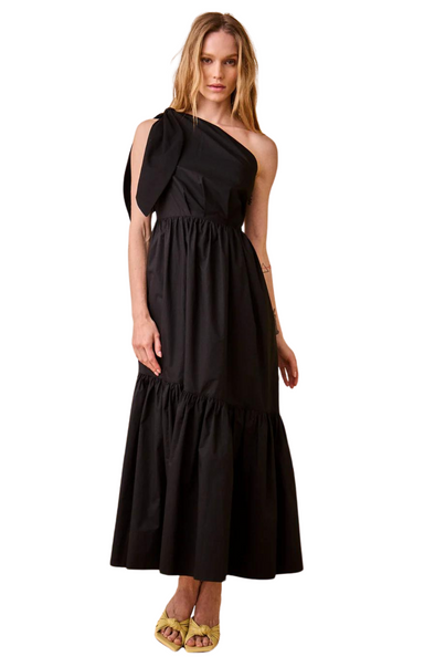 The Alana Dress by Hunter Bell features a self-tie one-shoulder neckline adorned with a striking bow to add a touch of sophistication and flair. The dress has a fitted waist that accentuates the silhouette, while tiered seams create beautiful flow and movement throughout the maxi-length skirt. Black maxi dress.